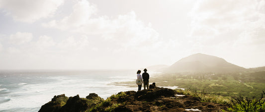 Two people stood on a cliff in low light