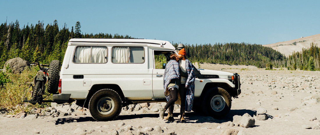 two people hugging next to their retro rig