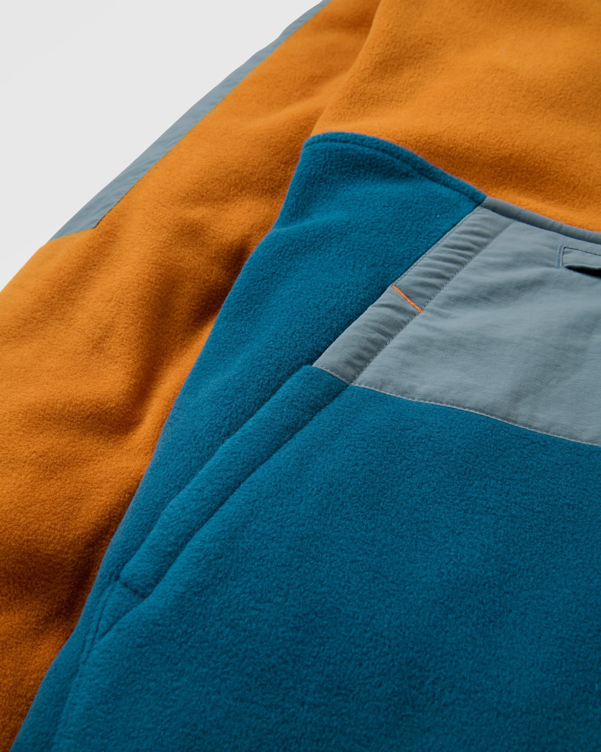 Woodland Hooded 1/2 Zip Recycled Polartec® Fleece - Retro Orange/Tidal Blue - Flatlay